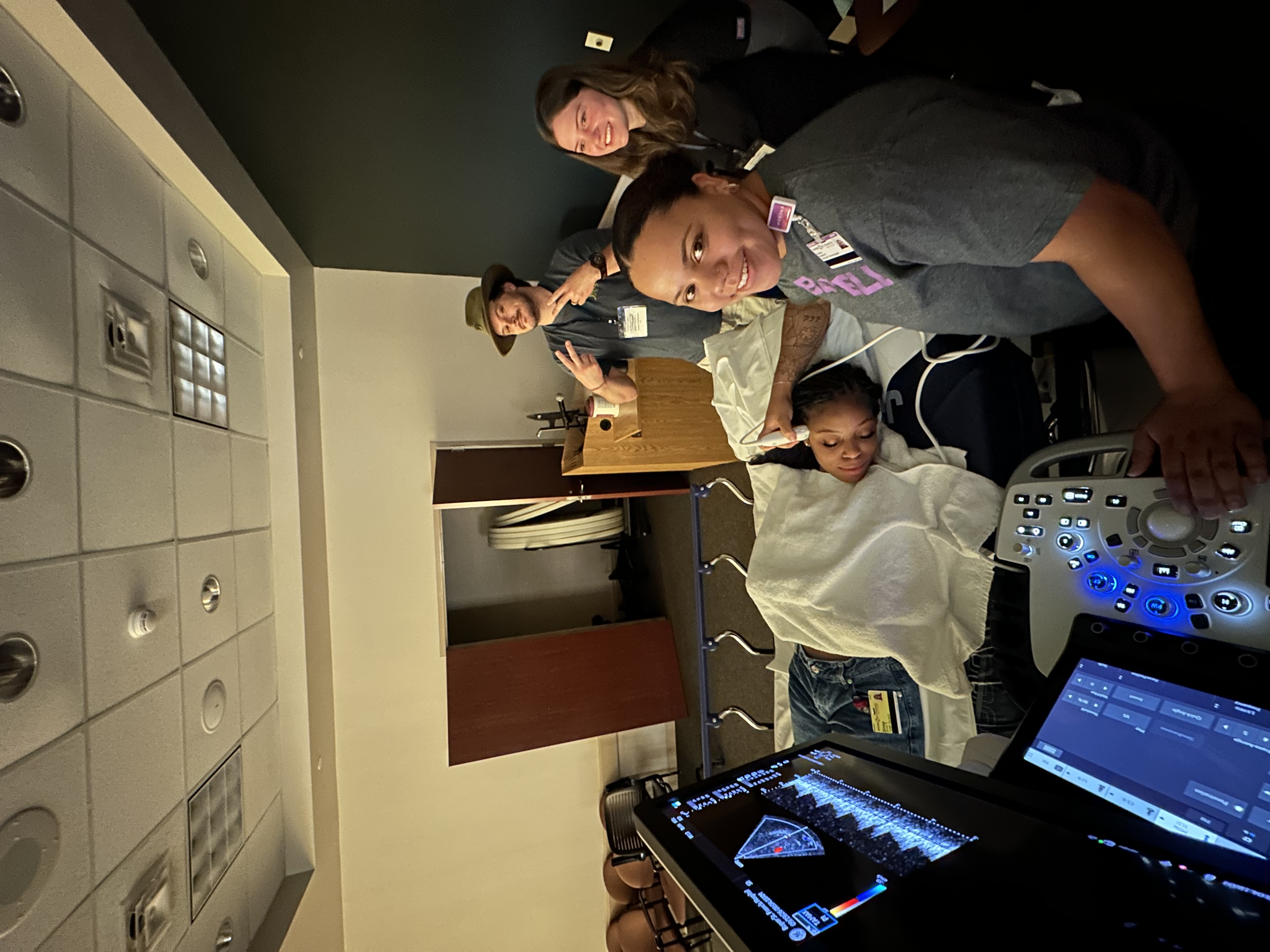 Participants and instructors during hands-on transcranial Doppler ultrasound training at Roper Hospital in South Carolina.